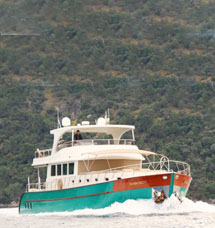 Tunes Travel motor yacht cruising at sea